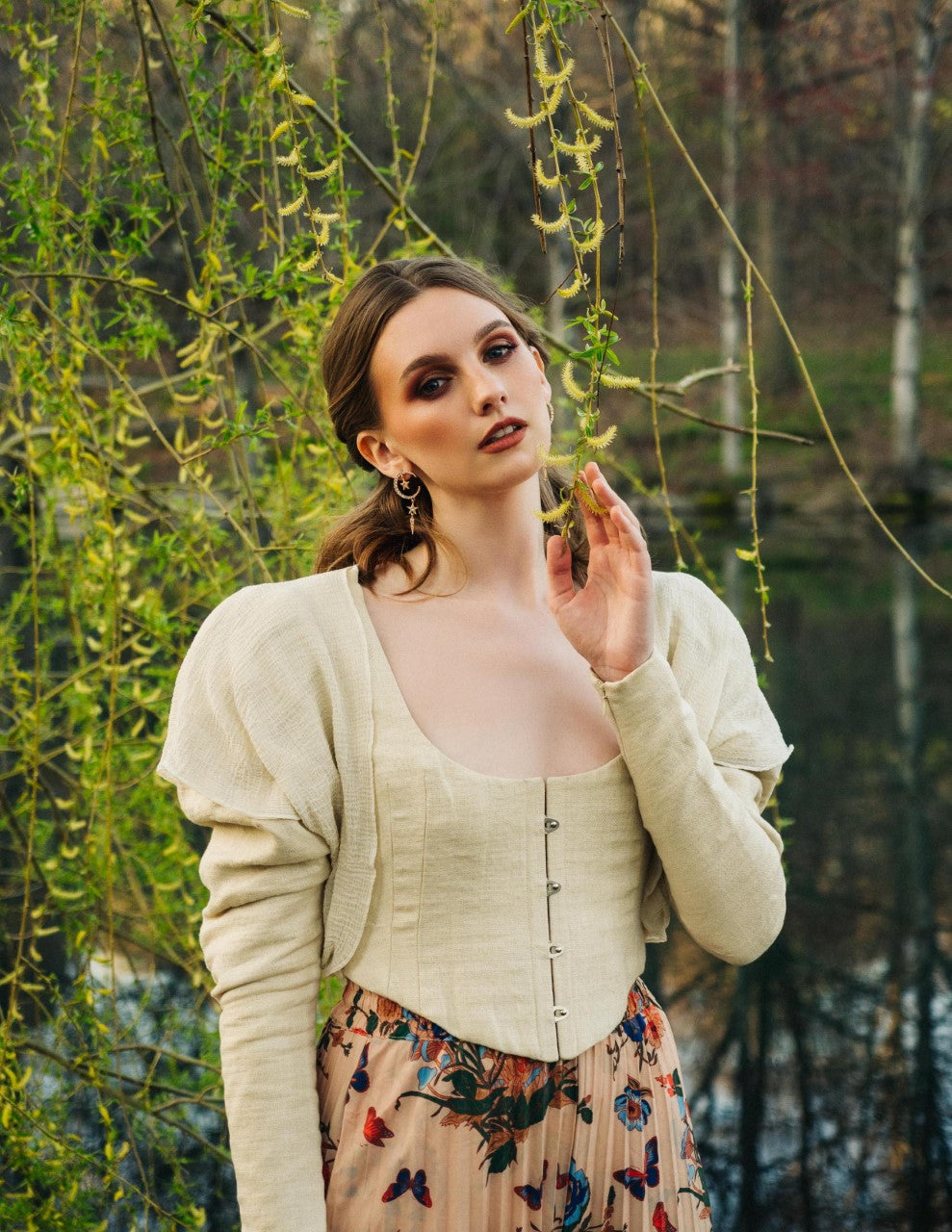 Woman wearing corset jacket over a floral skirt