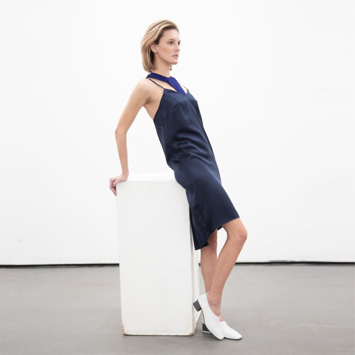 Woman in double layer navy Silk dress and white shoes
