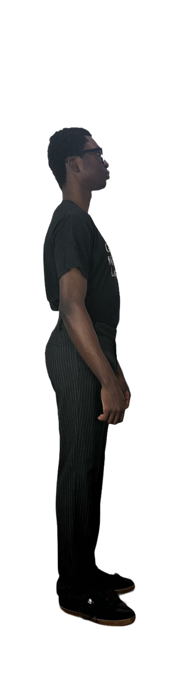 Side of man in a graphic t shirt wearing black and white stripe pants