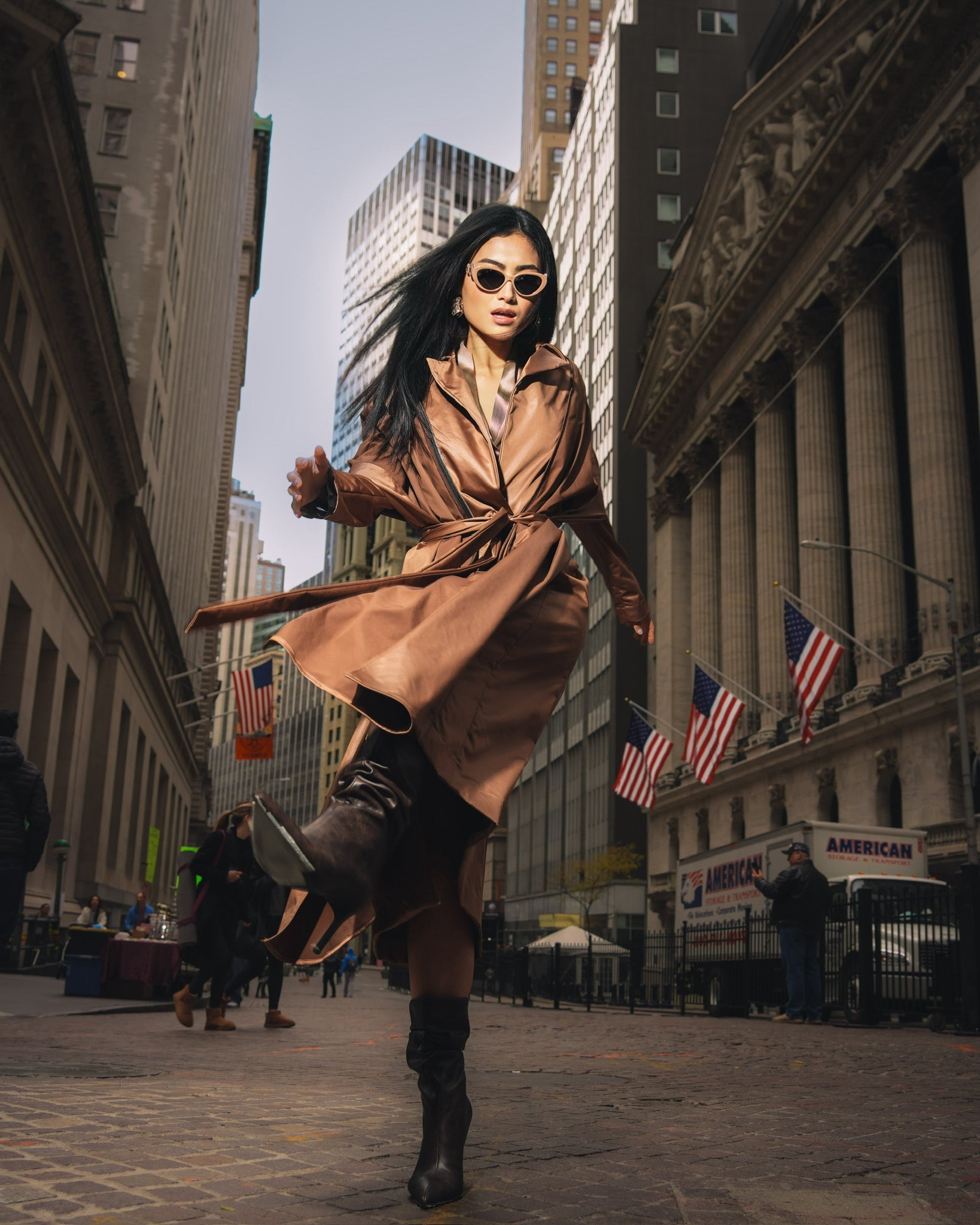 Woman posing with sunglasses and copper stretch satin coat with transformable zippers and self tie belt
