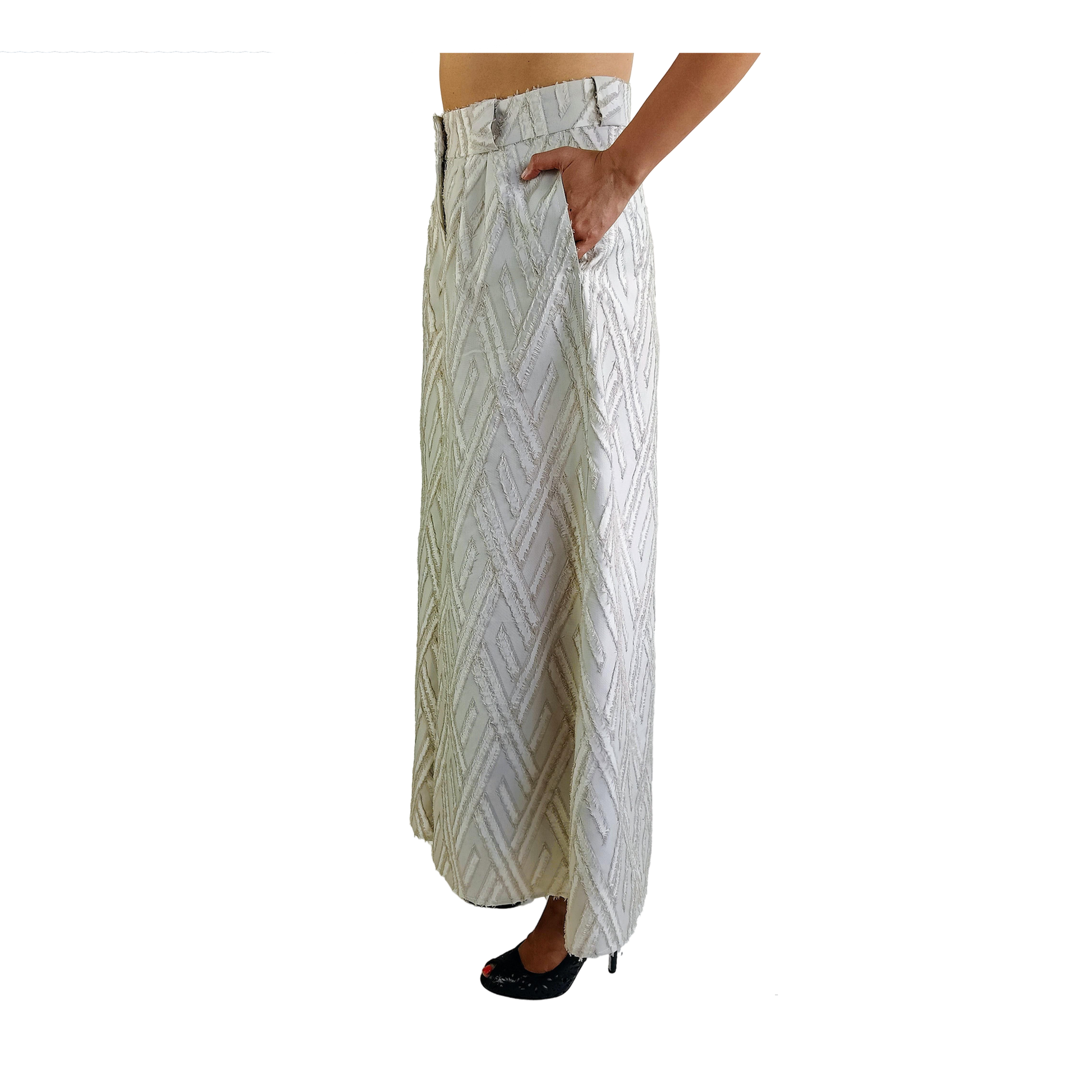 Woman turned to the side wearing a white wide legged wool pants with frayed herringbone detailing
