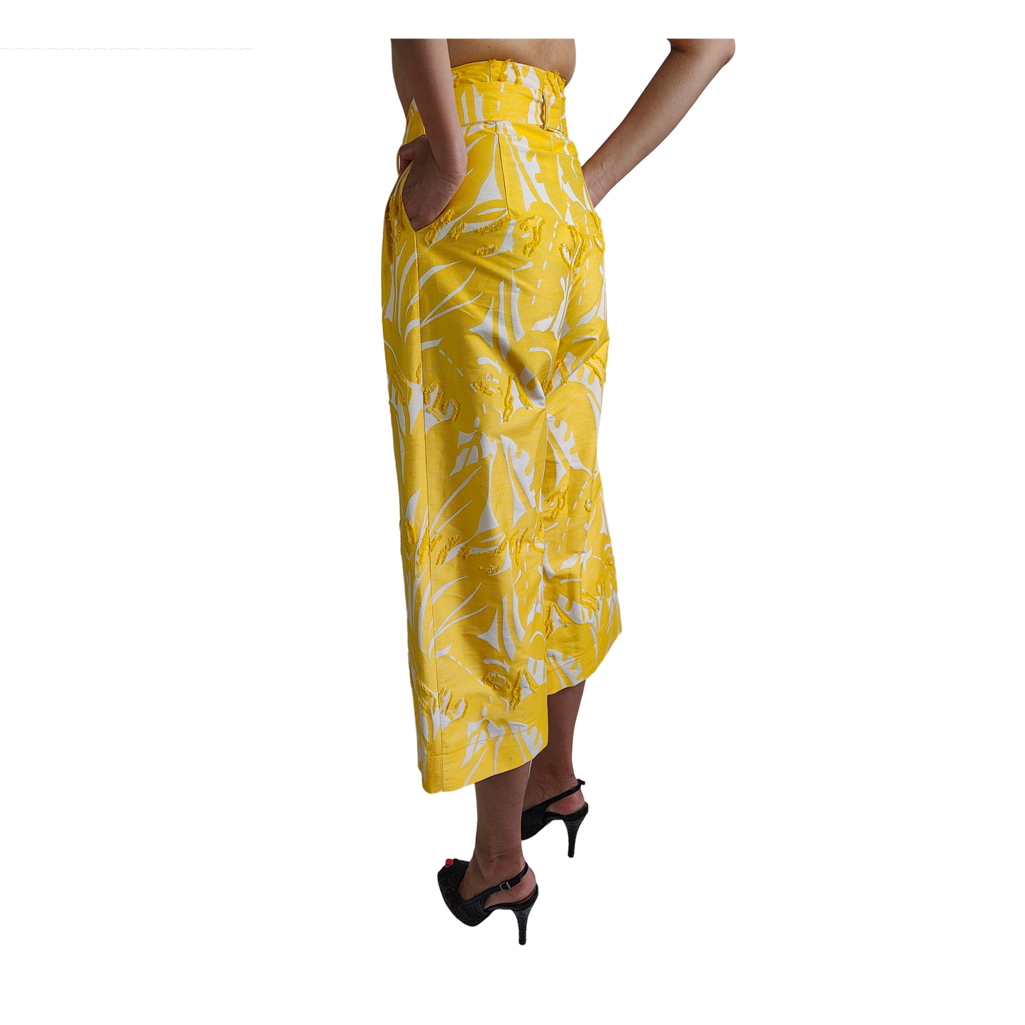 Side of reversible yellow cropped wide leg gaucho style pant with white patterns
