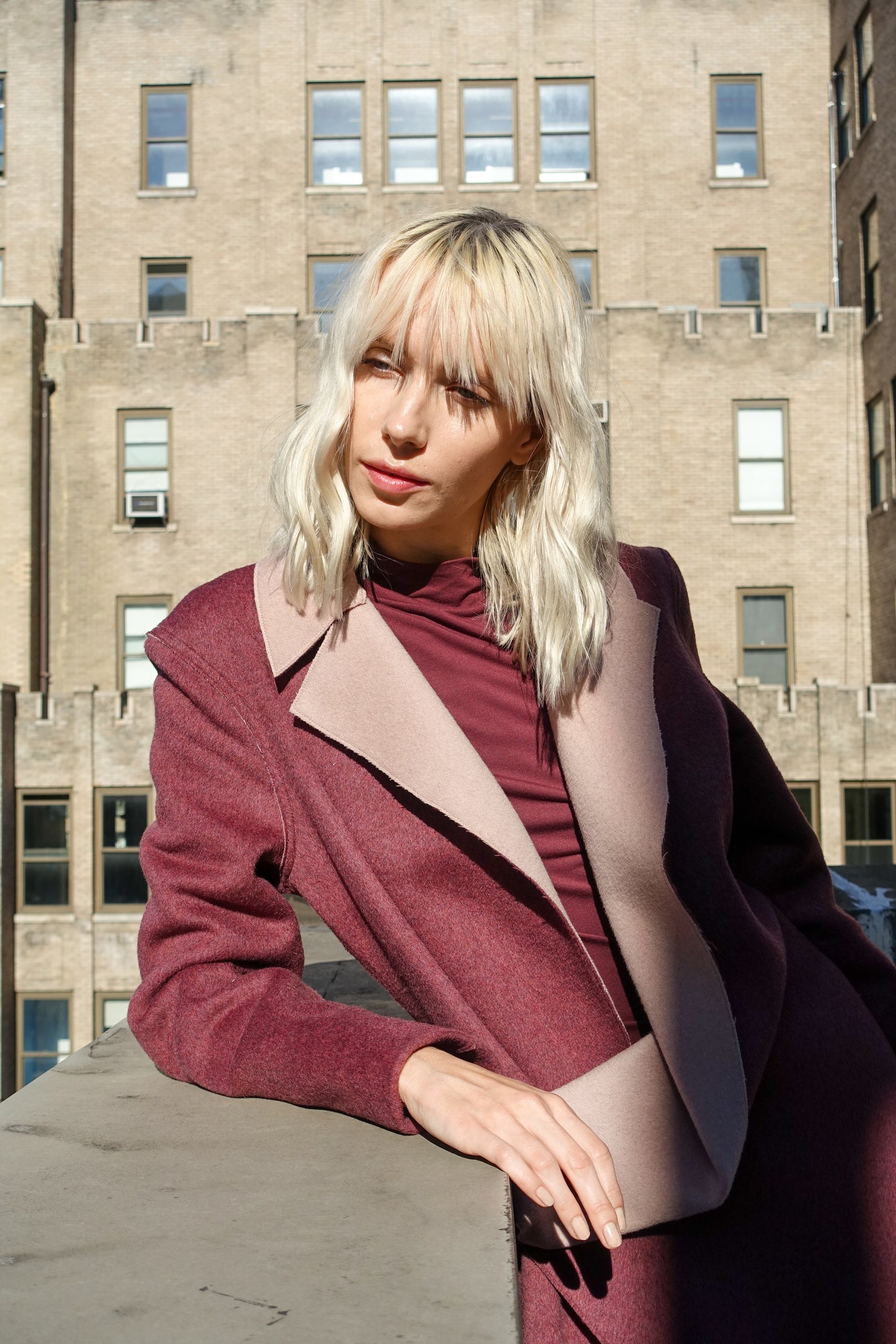 Woman posing in a tailored look double-face wool and cashmere blend raspberry pink coat