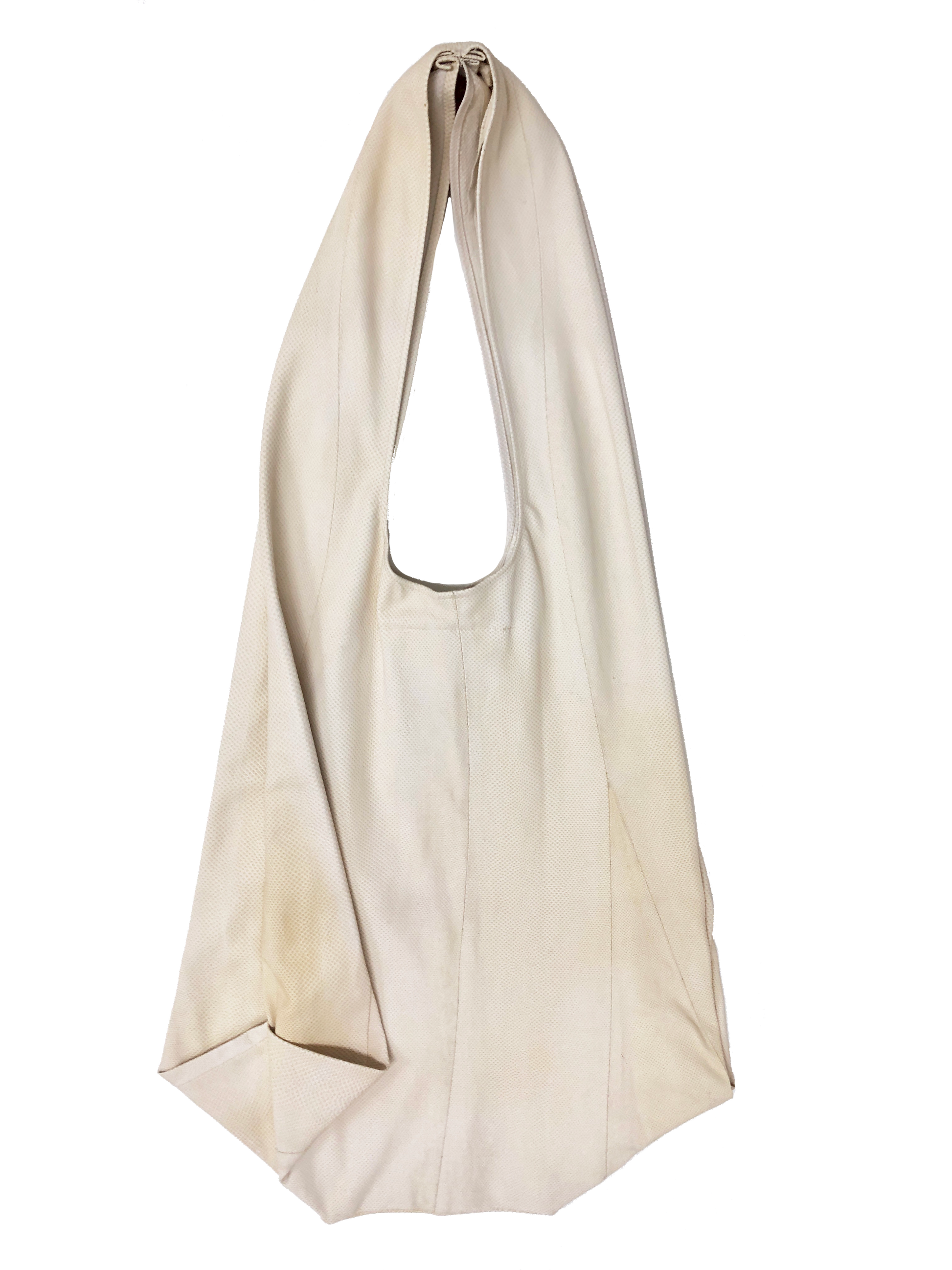 Side of beige acrochordus snakeskin tote bag with wide shoulder strap