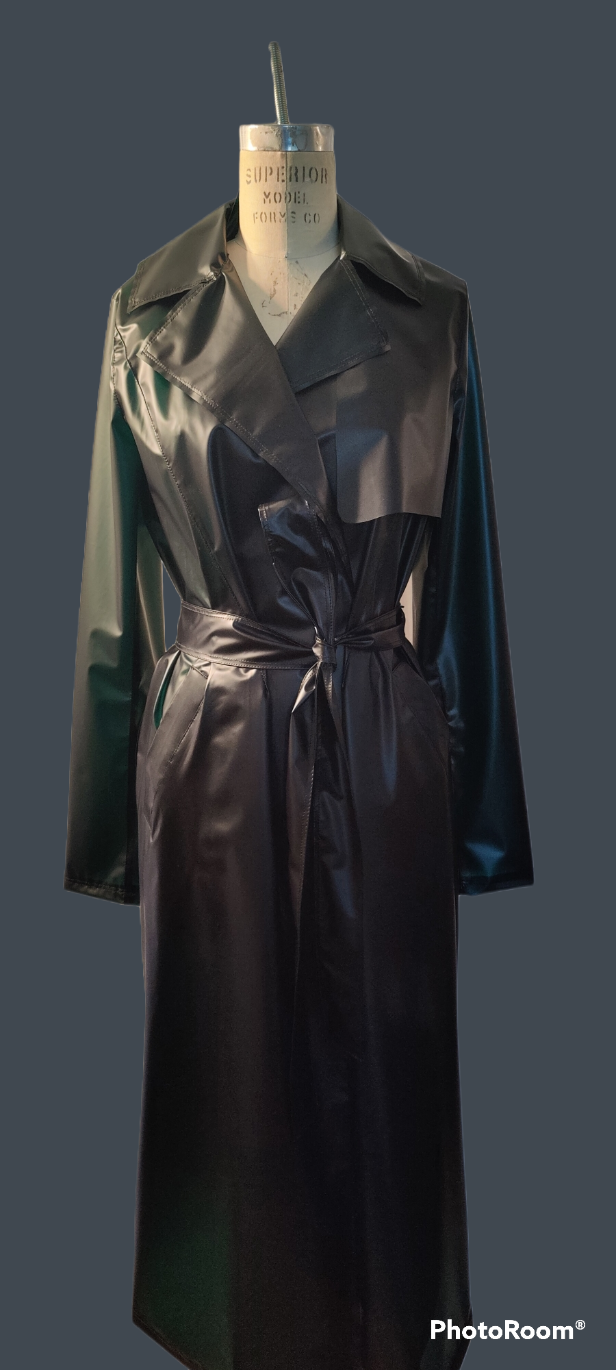 Black lacquer leather trench coast with double breasted detail and waist belt